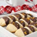 Cardamom Orange Almond Flour Cookies lined up on a white square plate