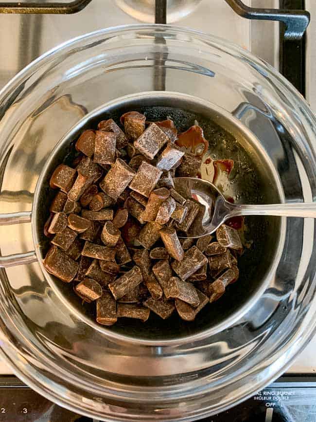 Melting chocolate in a glass bowl over a pan of boiling water.