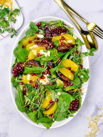 Spinach Salad with Oranges Dates and Pomegranate overhead view