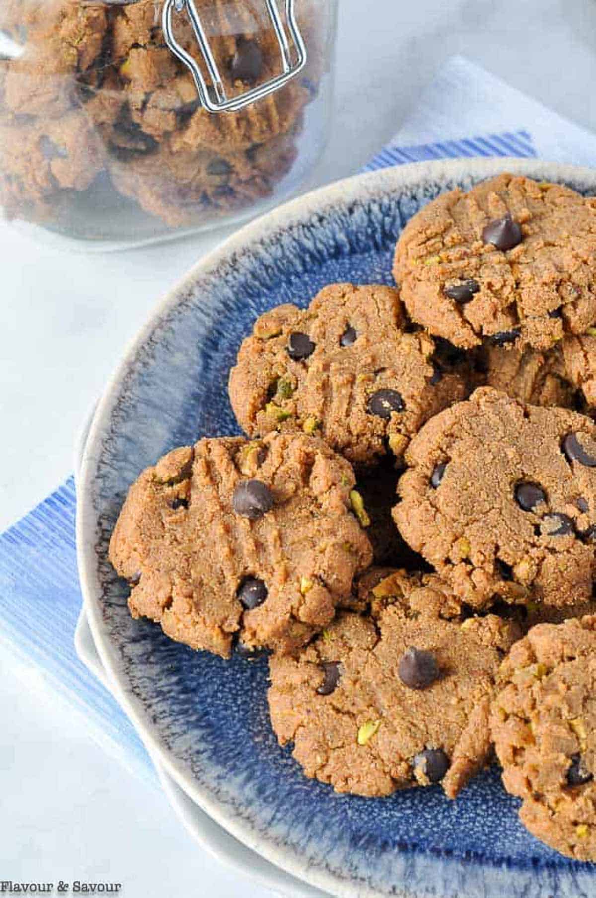 Flourless almond butter chocolate chip cookies on a blue plate.