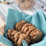 Almond Butter cookies in a basket with a cookie jar in the background.