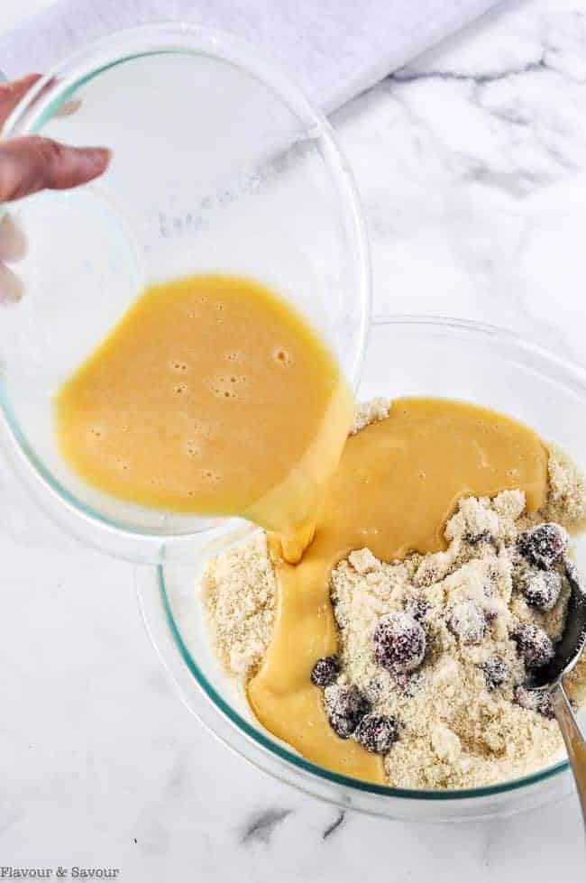 Adding wet ingredients to dry ingredients to make Keto Quick Bread.