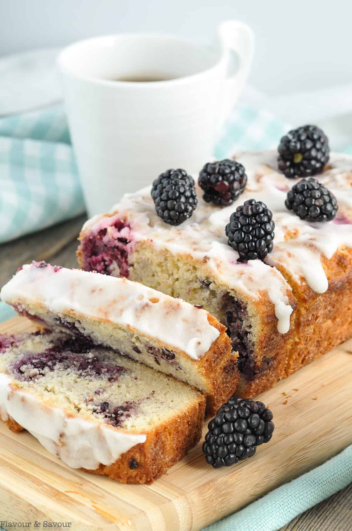 A sliced loaf of keto blackberry loaf.