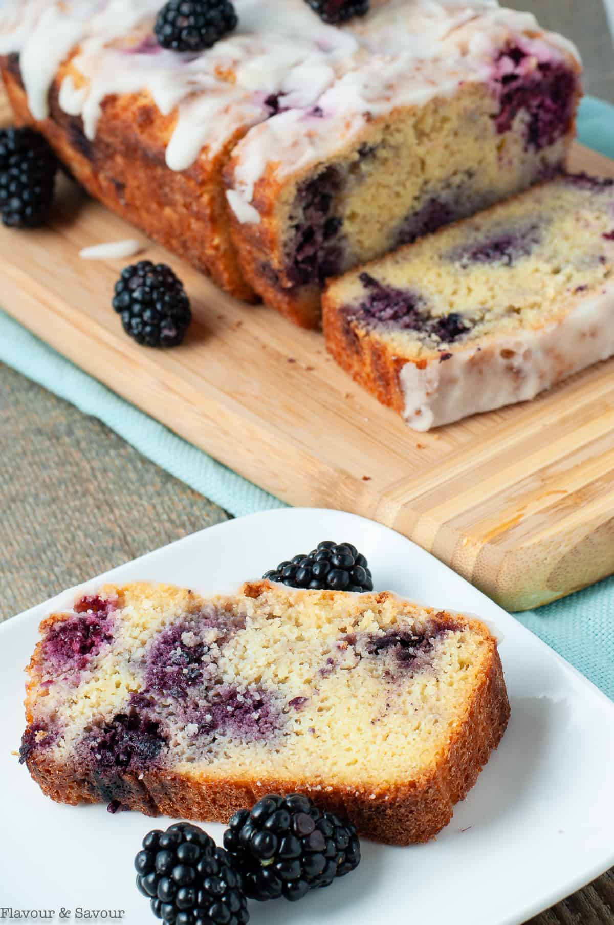 Keto blackberry loaf with a slice on a plate.