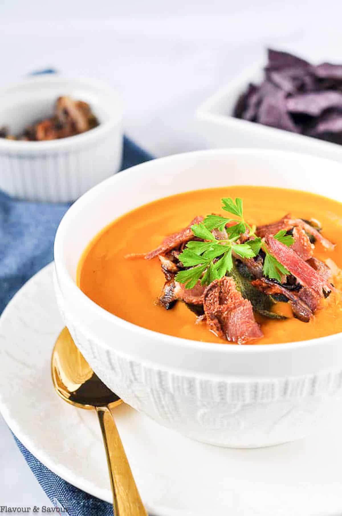 Side view of a bowl of butternut squash soup.