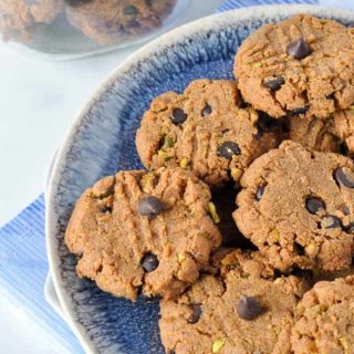 Almond Butter Chocolate Chip Cookies on a blue stoneware plate.