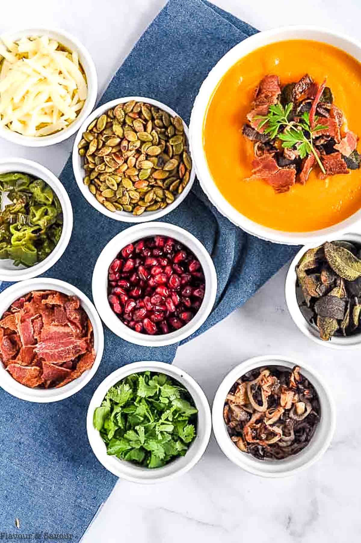 Small bowls filled with soup topping ingredients.