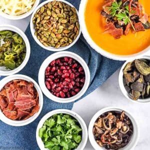 Overhead view of small bowls filled with soup topping ingredients.