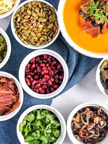 Overhead view of small bowls filled with soup topping ingredients.