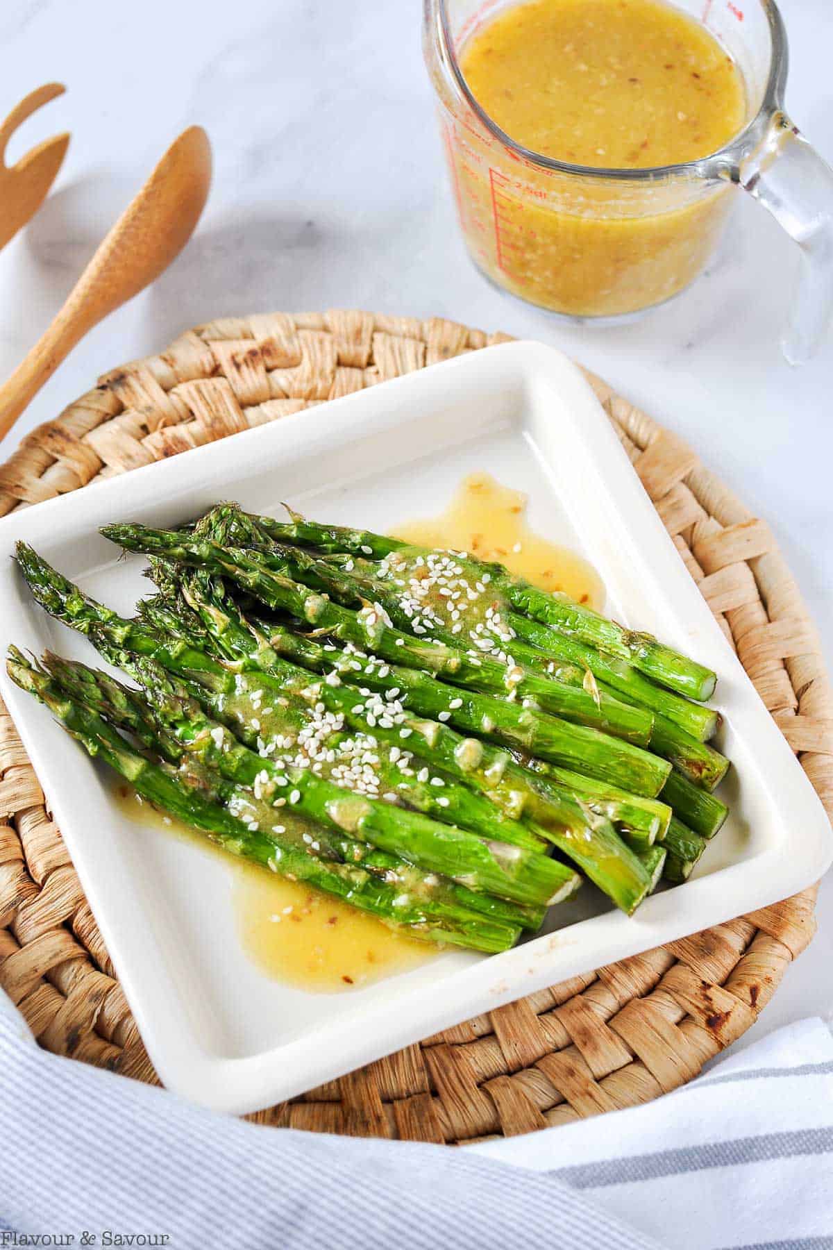 Air Fryer Roasted Asparagus drizzled with sesame miso sauce and sesame seeds.