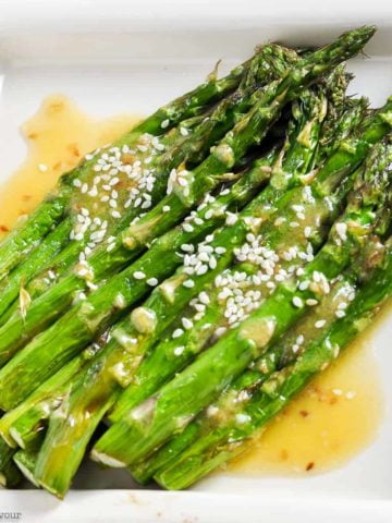 Roasted Asparagus with Sesame Miso Sauce on a square white dish