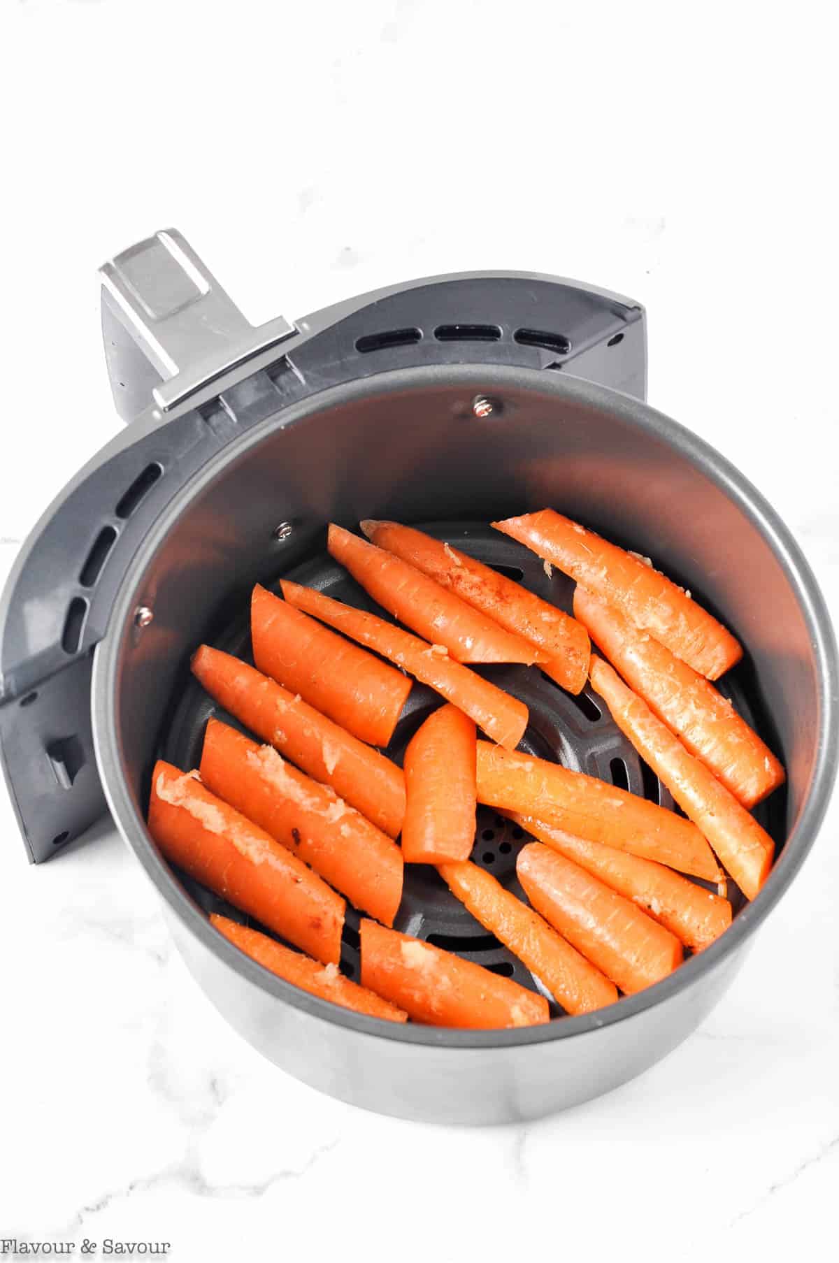Carrots in air fryer basket, ready to fry.