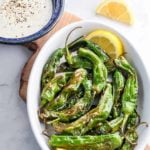 Air Fryer Shishito Peppers with Lemon Aioli Dip on a serving board