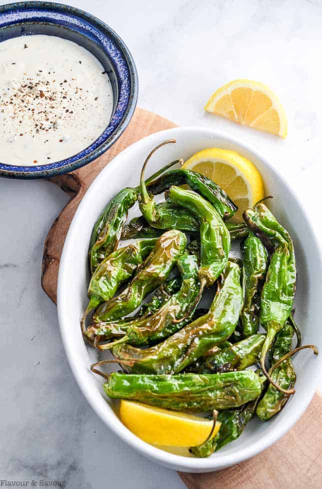 Air Fryer Shishito Peppers with Lemon Aioli Dip on a serving board