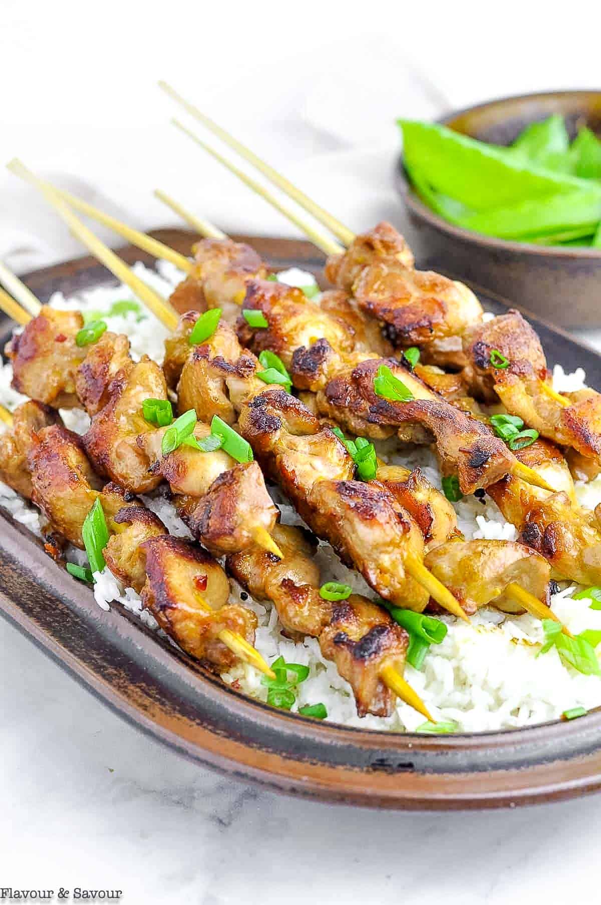 Thai Chicken Skewers on a bed of rice.