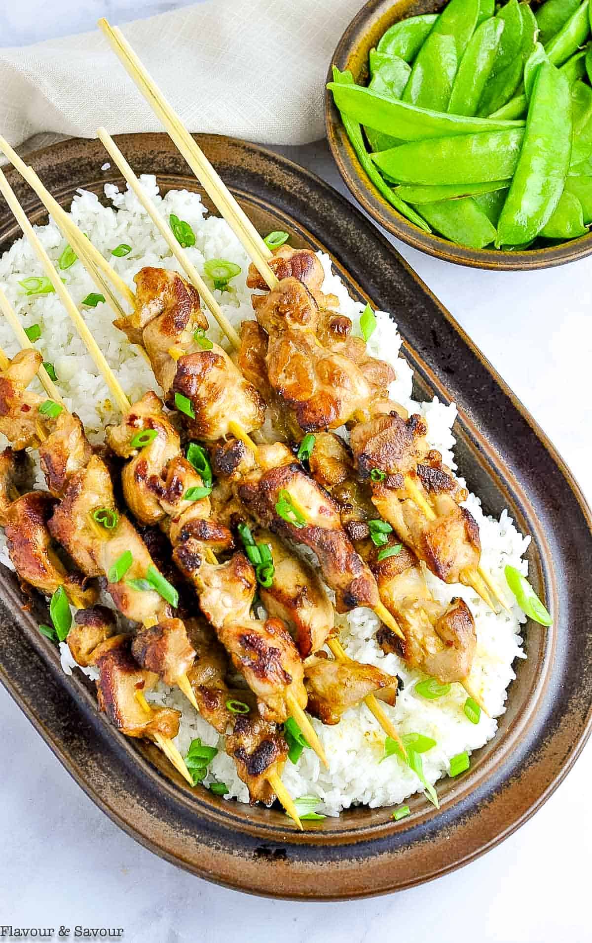 Overhead view of Easy Thai Chicken Skewers on a brown platter.