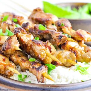 Easy Thai Chicken Skewers on a bed of rice.