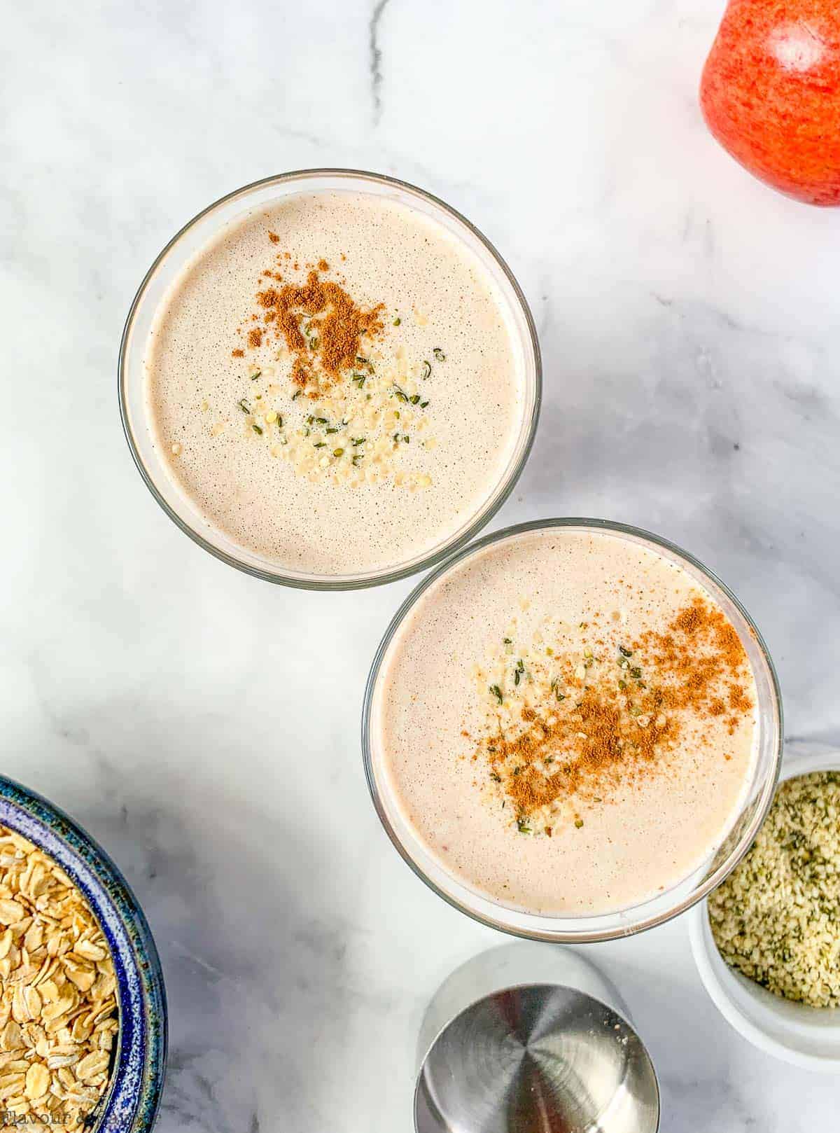 Overhead view of two glasses of Apple Oatmeal Breakfast Smoothie