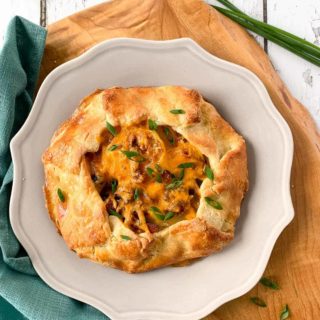Overhead view of Potato Galette with Bacon and Cheese with chive flowers