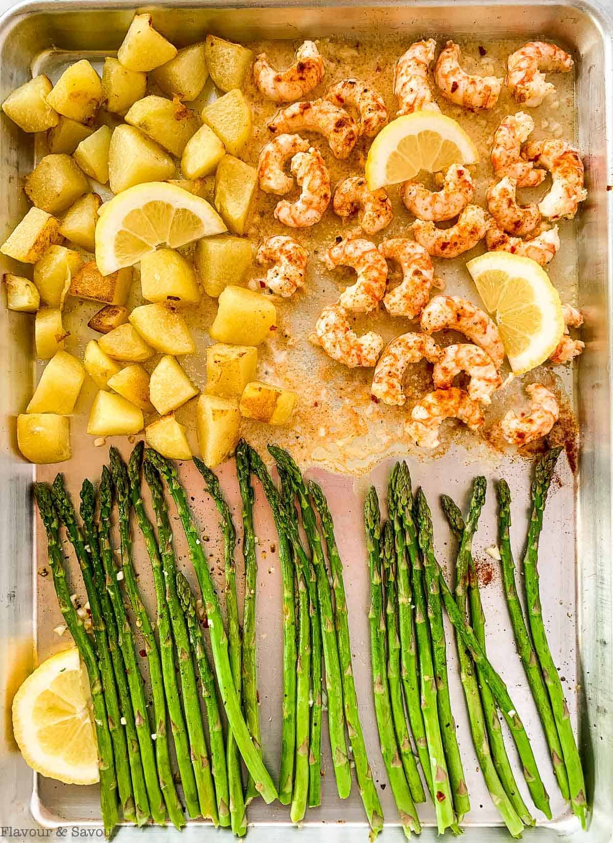 Potatoes, prawns and asparagus on a sheet pan