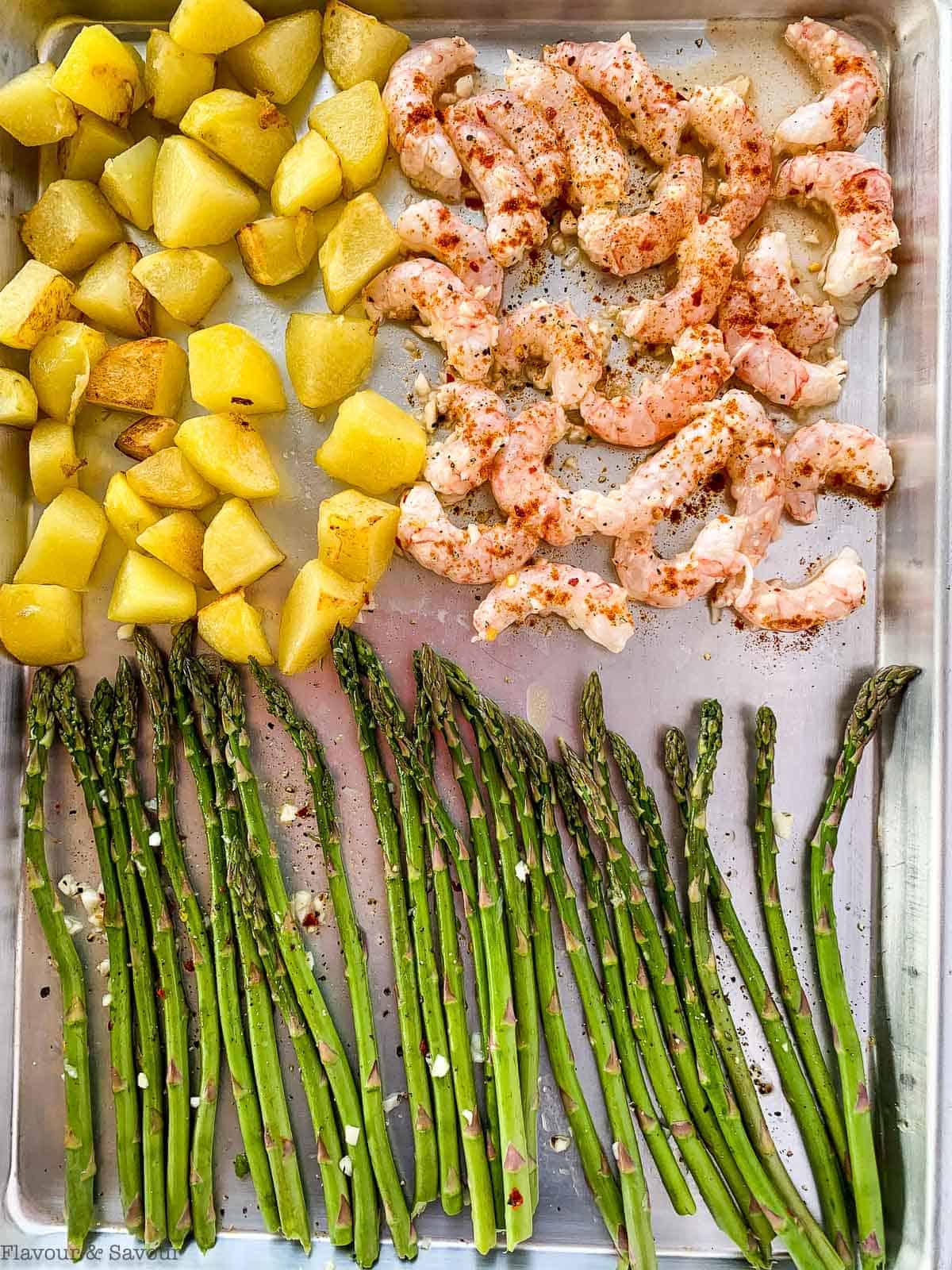 Sheet Pan Lemon Garlic Shrimp, asparagus and potatoes on a sheet pan ready to cook