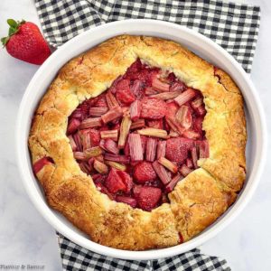 Overhead view of Strawberry Rhubarb Galette on a black plaid cloth