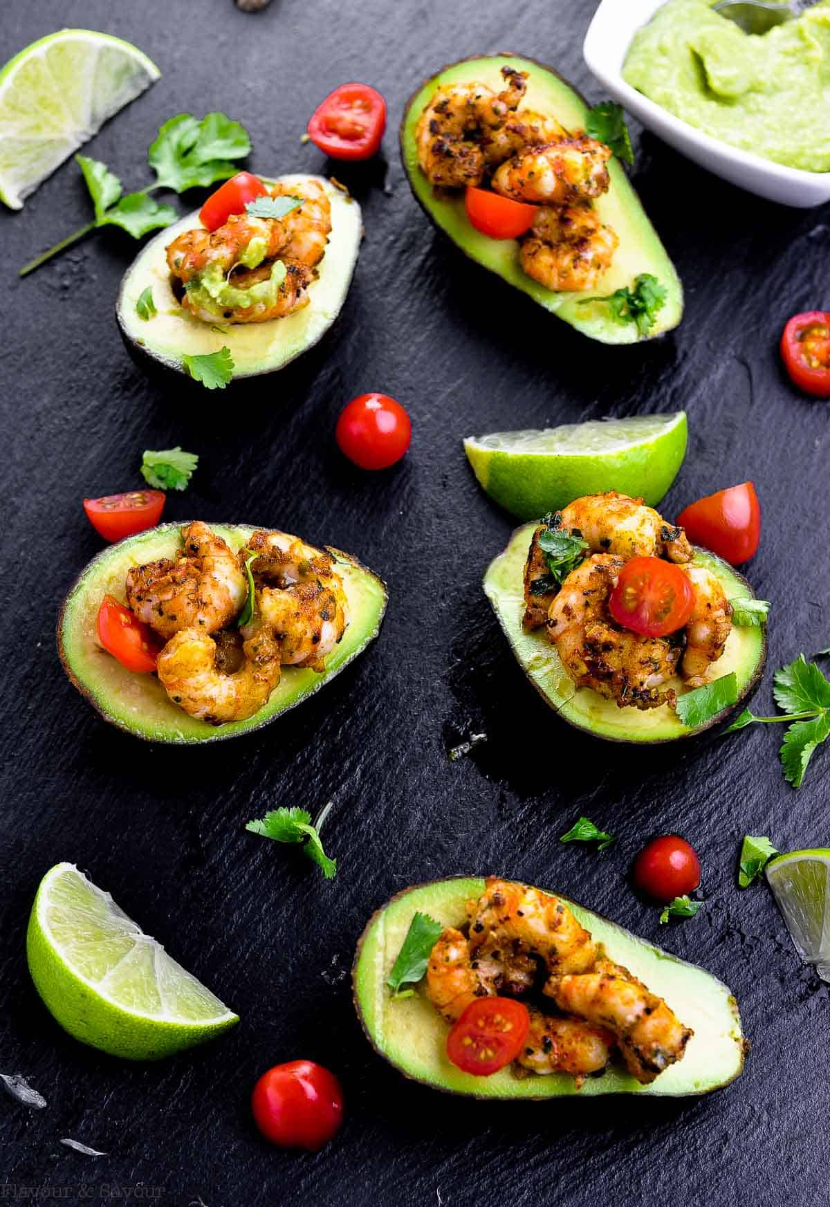 Cajun Shrimp Stuffed Avocados overhead view with cherry tomatoes and limes