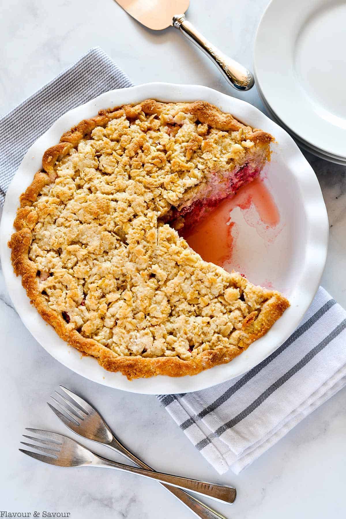 Baked Strawberry Rhubarb Crumb Pie with one slice removed.