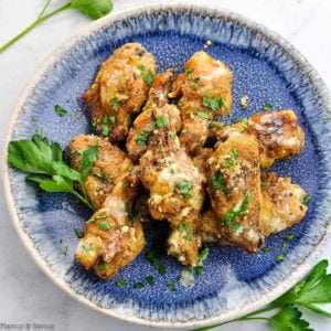 Overhead view of Air Fryer Garlic Parmesan Chicken Wings on a round blue plate