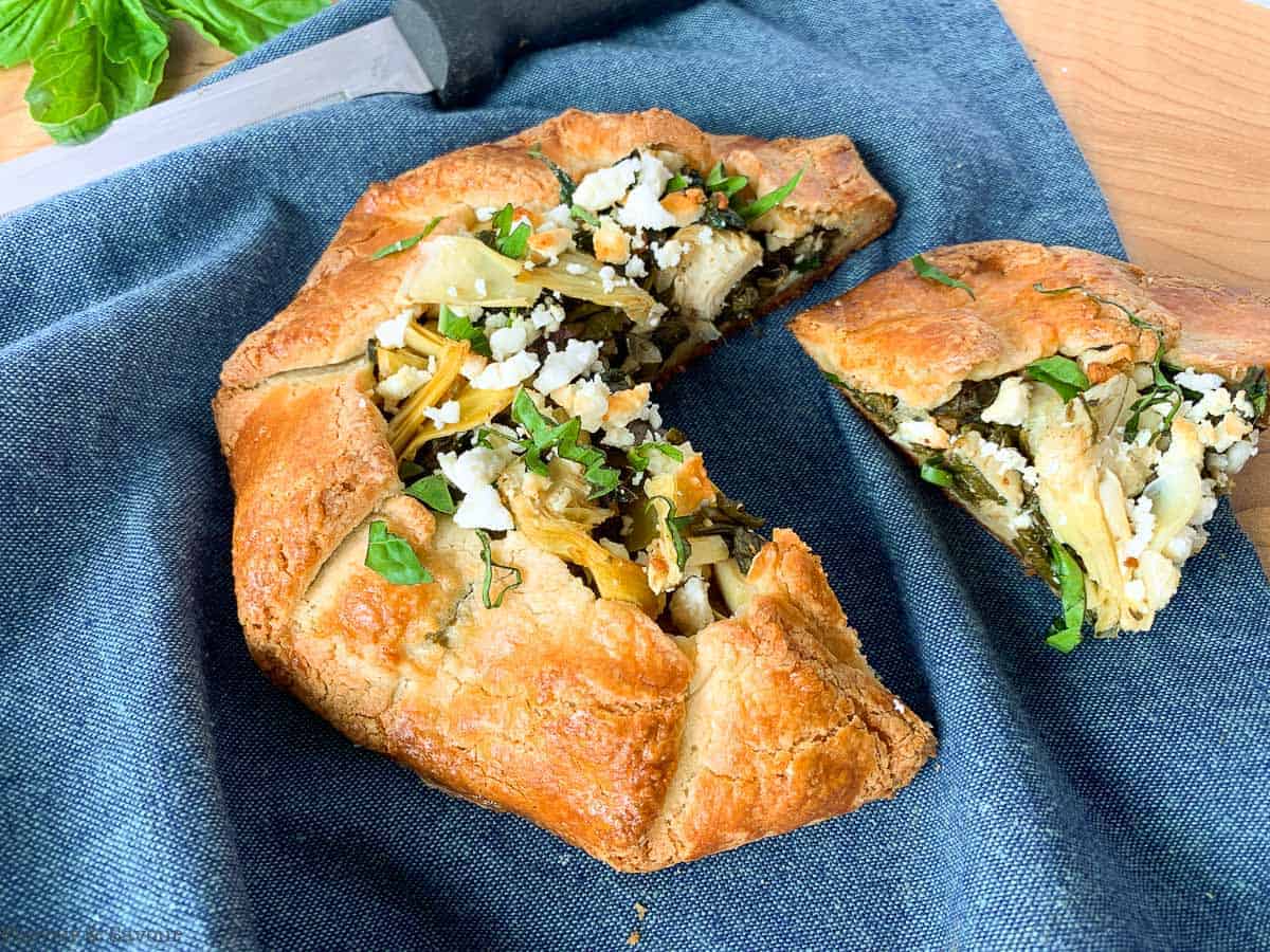 Spinach Artichoke Galette with one wedge removed from the pie.