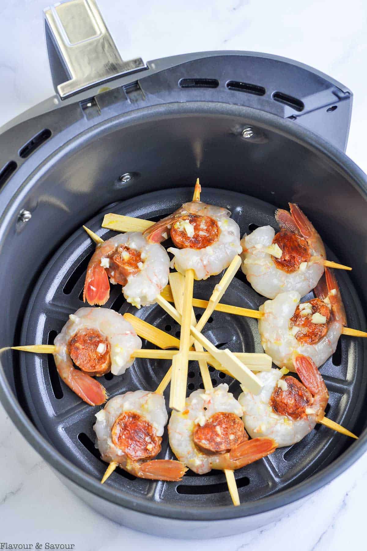 Prawn and Chorizo Skewers in an air fryer basket before being cooked