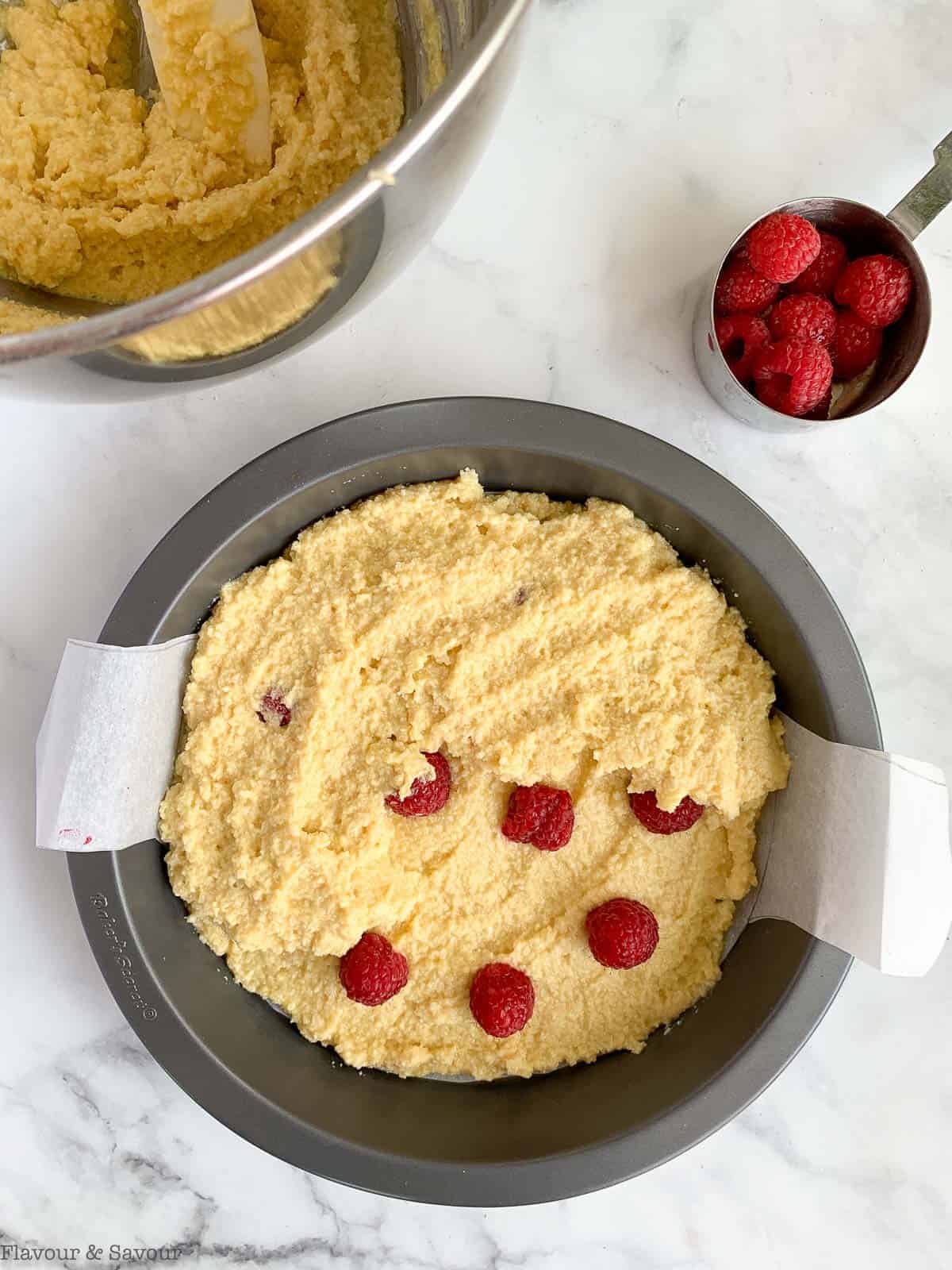 Cover first layer of raspberries with more batter