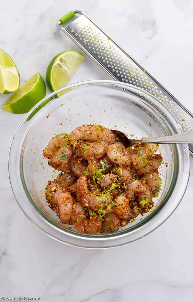 Tossing prawns or shrimp with Cajun spices for Shrimp Stuffed Avocado boats