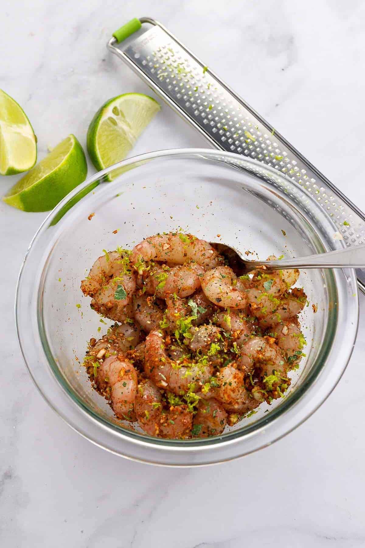 Tossing prawns or shrimp with Cajun spices for Shrimp Stuffed Avocado boats