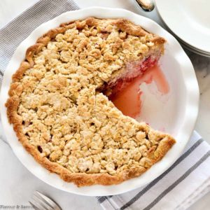 Strawberry Rhubarb Crumble Pie with one slice removed