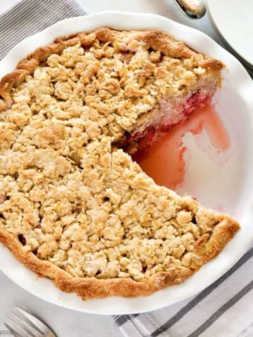 Strawberry Rhubarb Crumble Pie with one slice removed