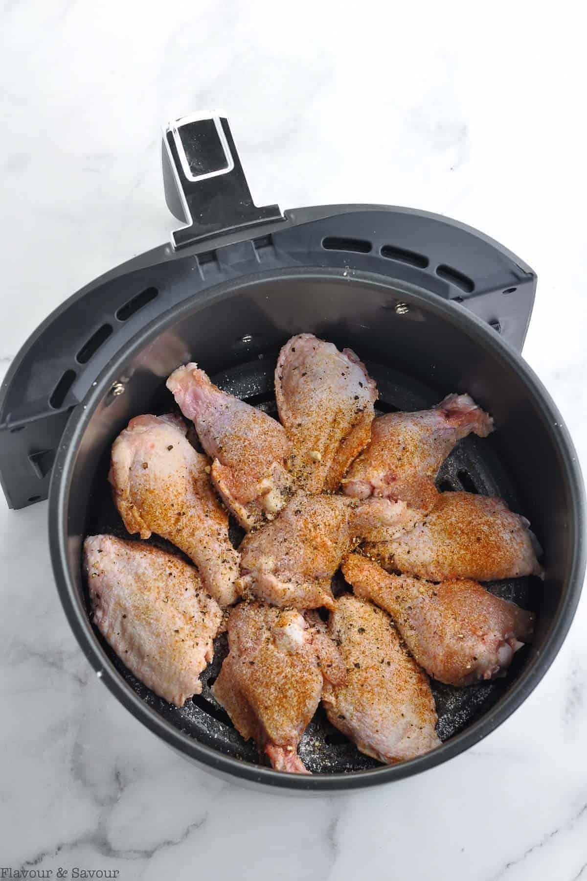 Uncooked chicken wings sprinkled with seasonings
