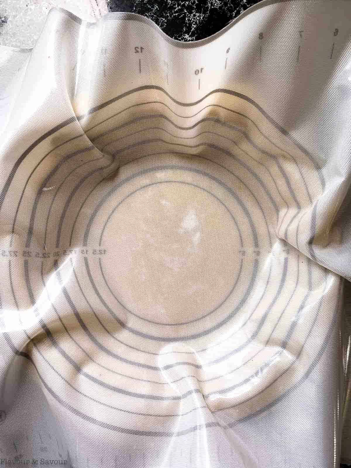 Inverting a pastry mat to fill pie plate with a gluten-free almond flour pastry crust. 