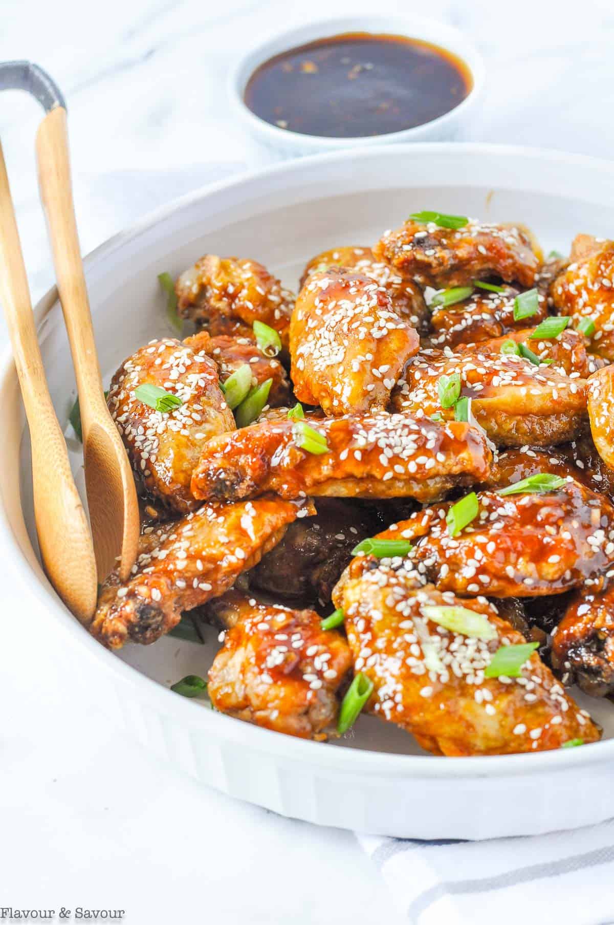 Air Fryer Teriyaki Chicken Wings with dipping sauce and tongs