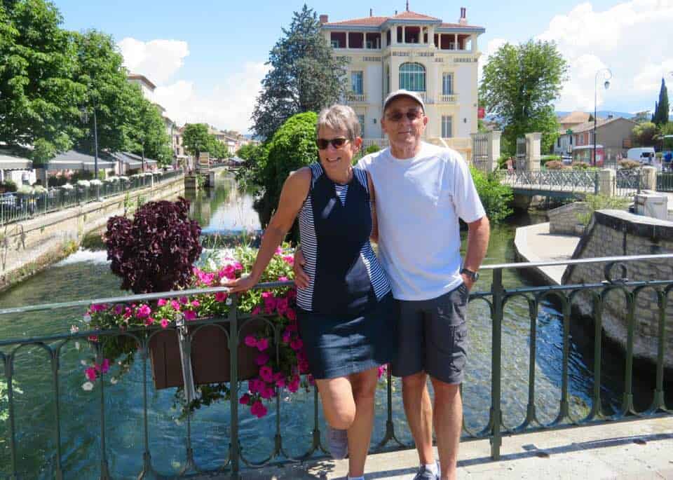 Elaine and Denis on a bridge with flowers