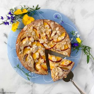Overhead view of a partially sliced Nectarine Ricotta Cake