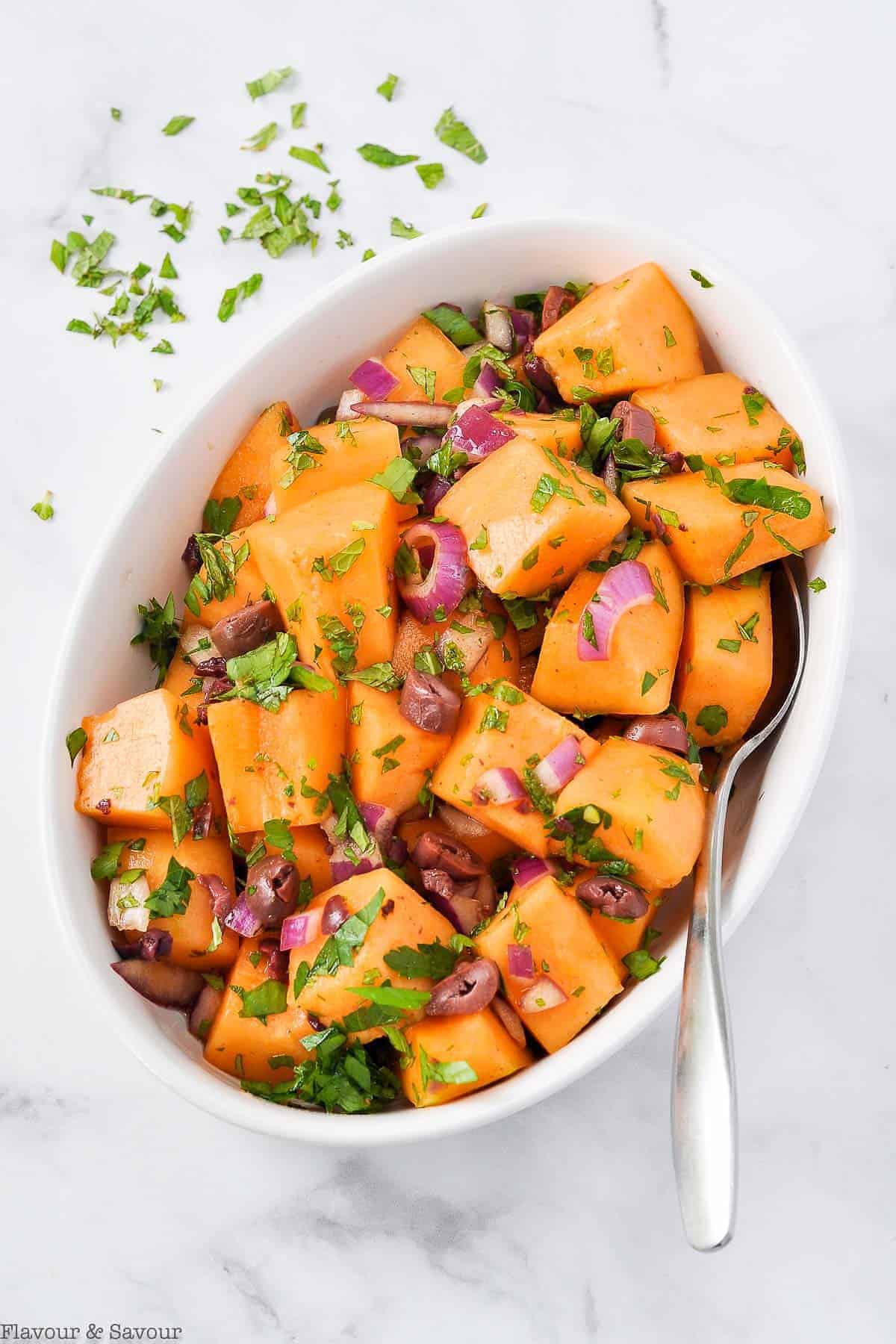 Mediterranean Cantaloupe Salad with red onion, olives and mint.