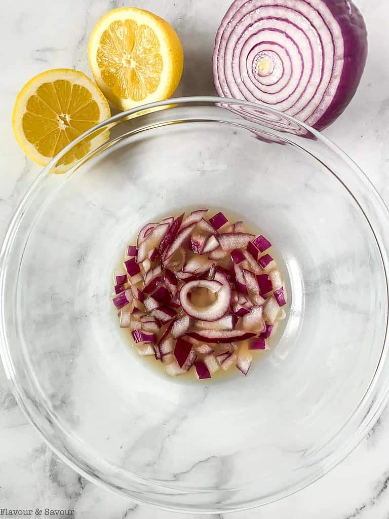 Red onion and lemon juice in a bowl