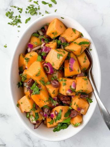 Mediterranean Cantaloupe Salad in a white oval bowl