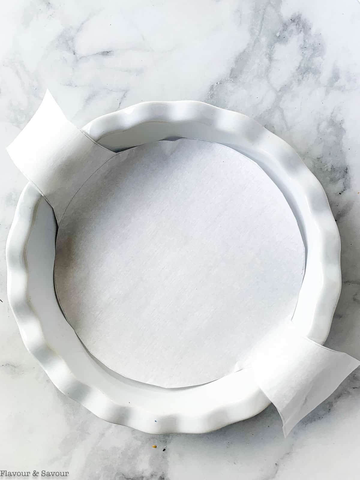 A round cake pan lined with parchment paper