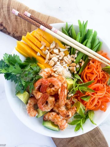 Overhead view of Vietnamese Prawn Noodle Bowl on a board with chopsticks