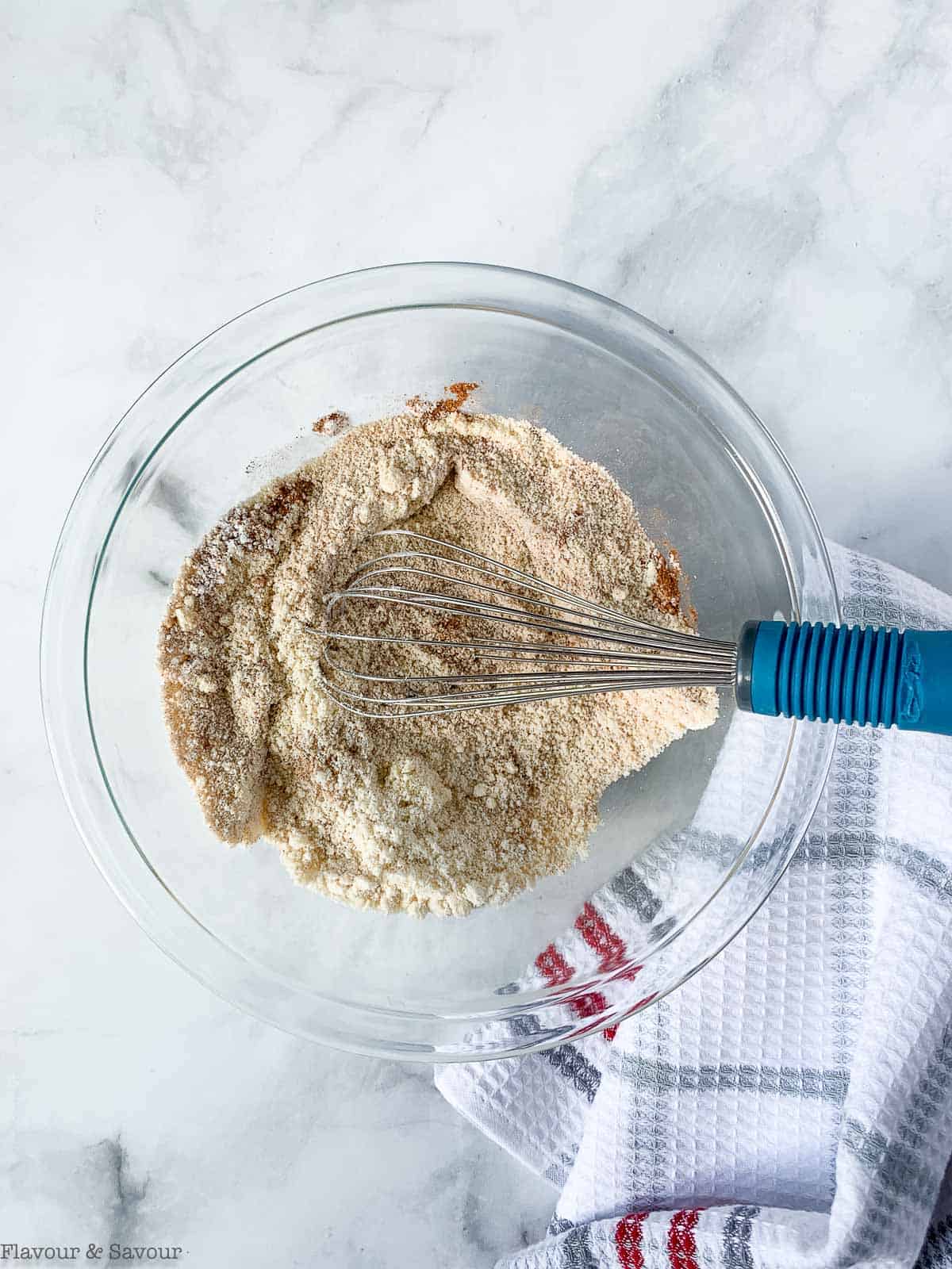 Whisking dry ingredients in a glass bowl