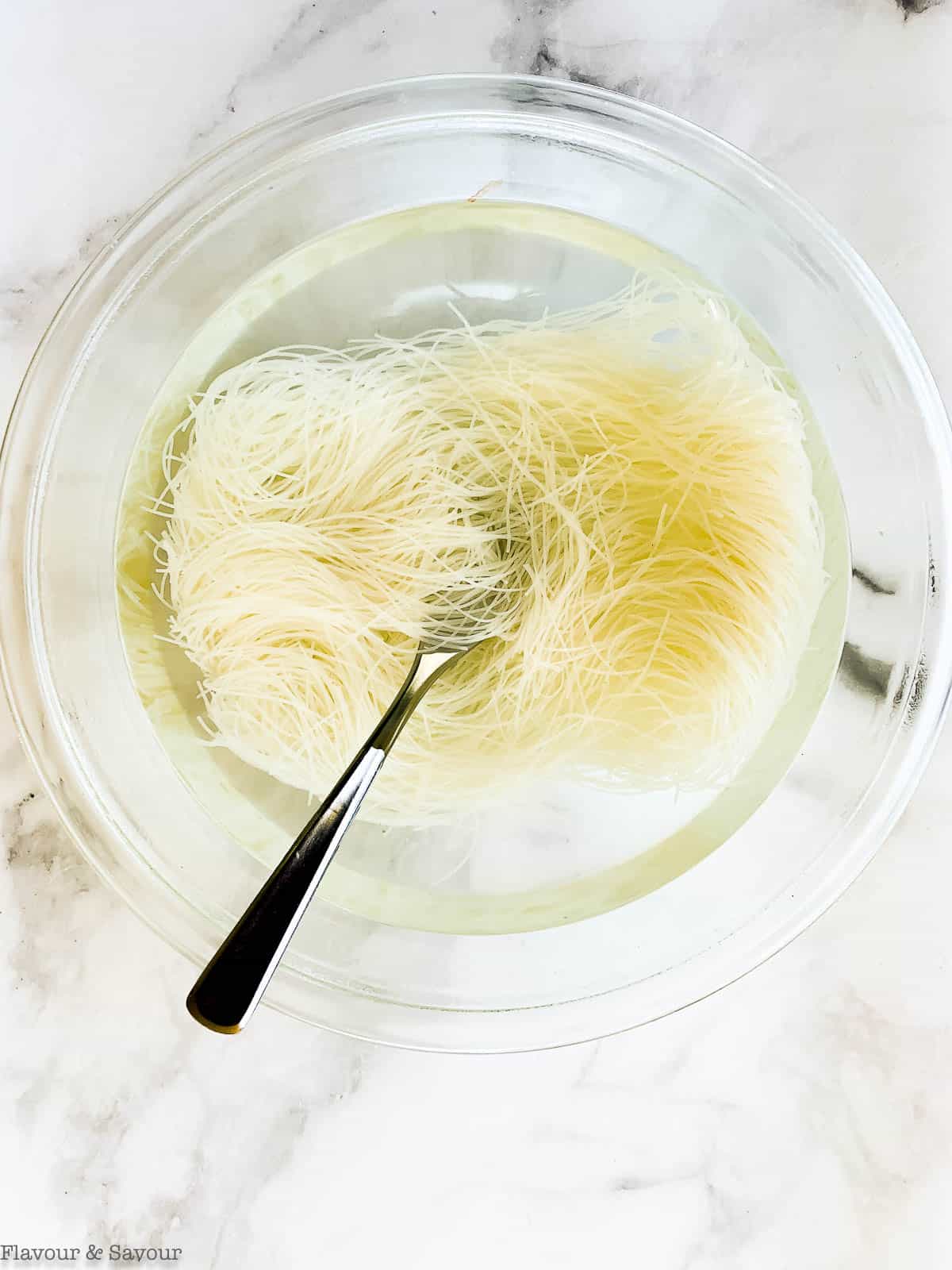 Vermicelli rice noodles in a glass bowl.