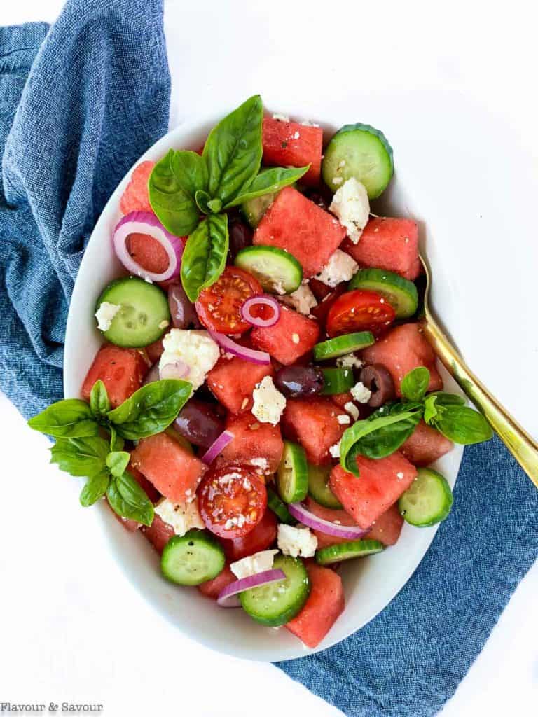 Greek Watermelon Basil Salad on a blue cloth