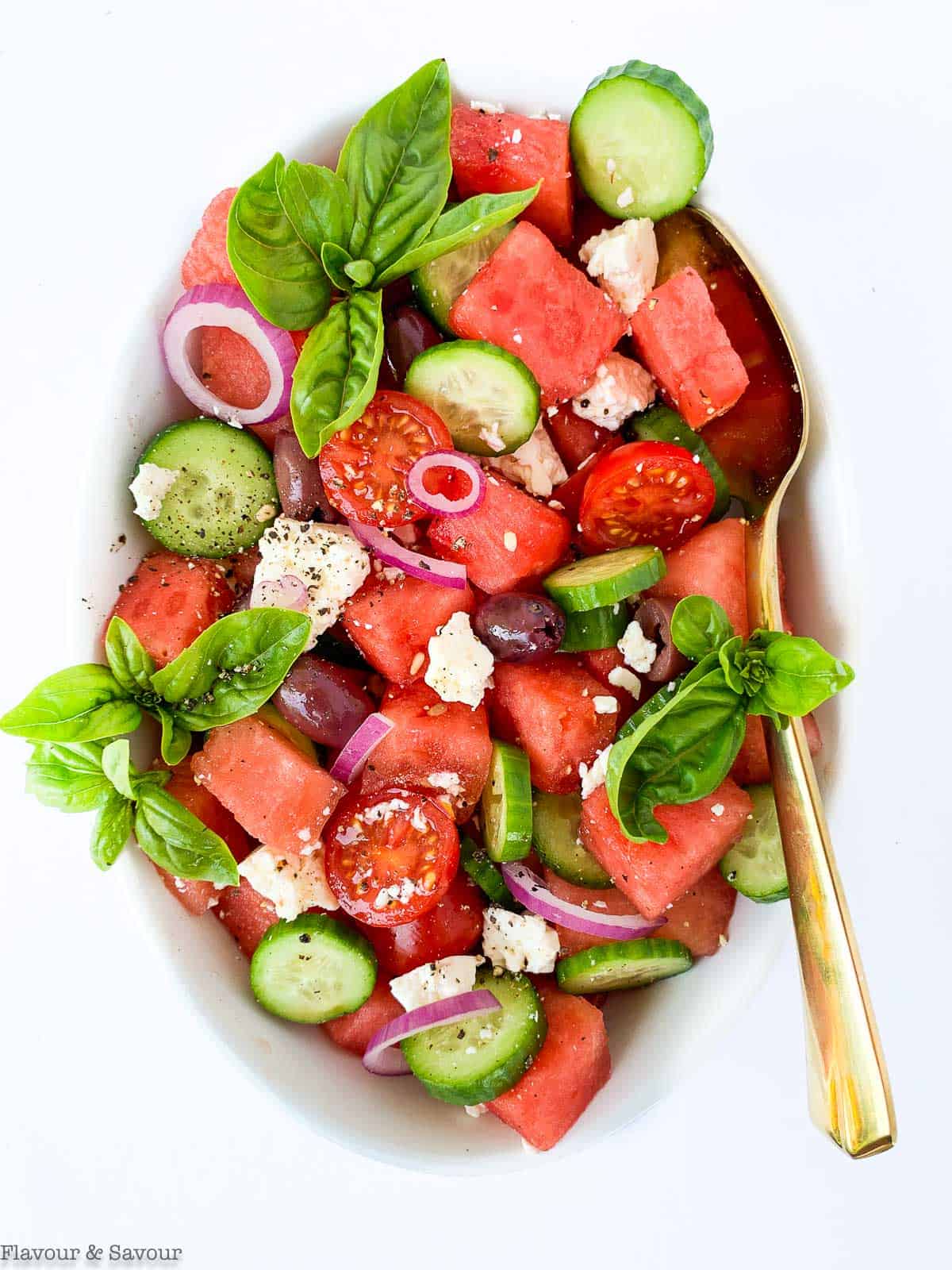 Greek Watermelon Basil Salad overhead view with a gold spoon